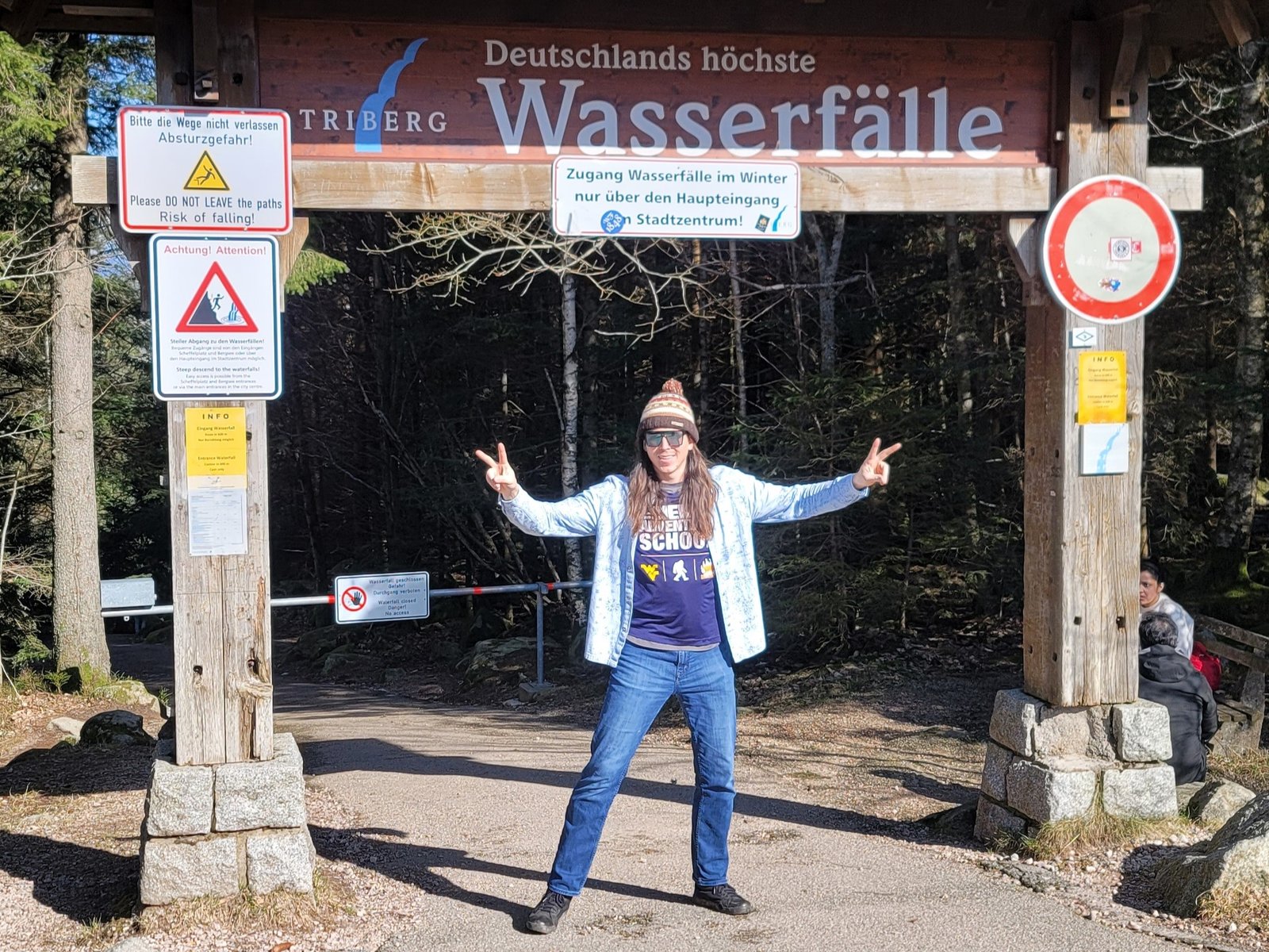 Posing with Peace Sign in front of Triberg Vasserfal (Waterfall) in the German Black Forest